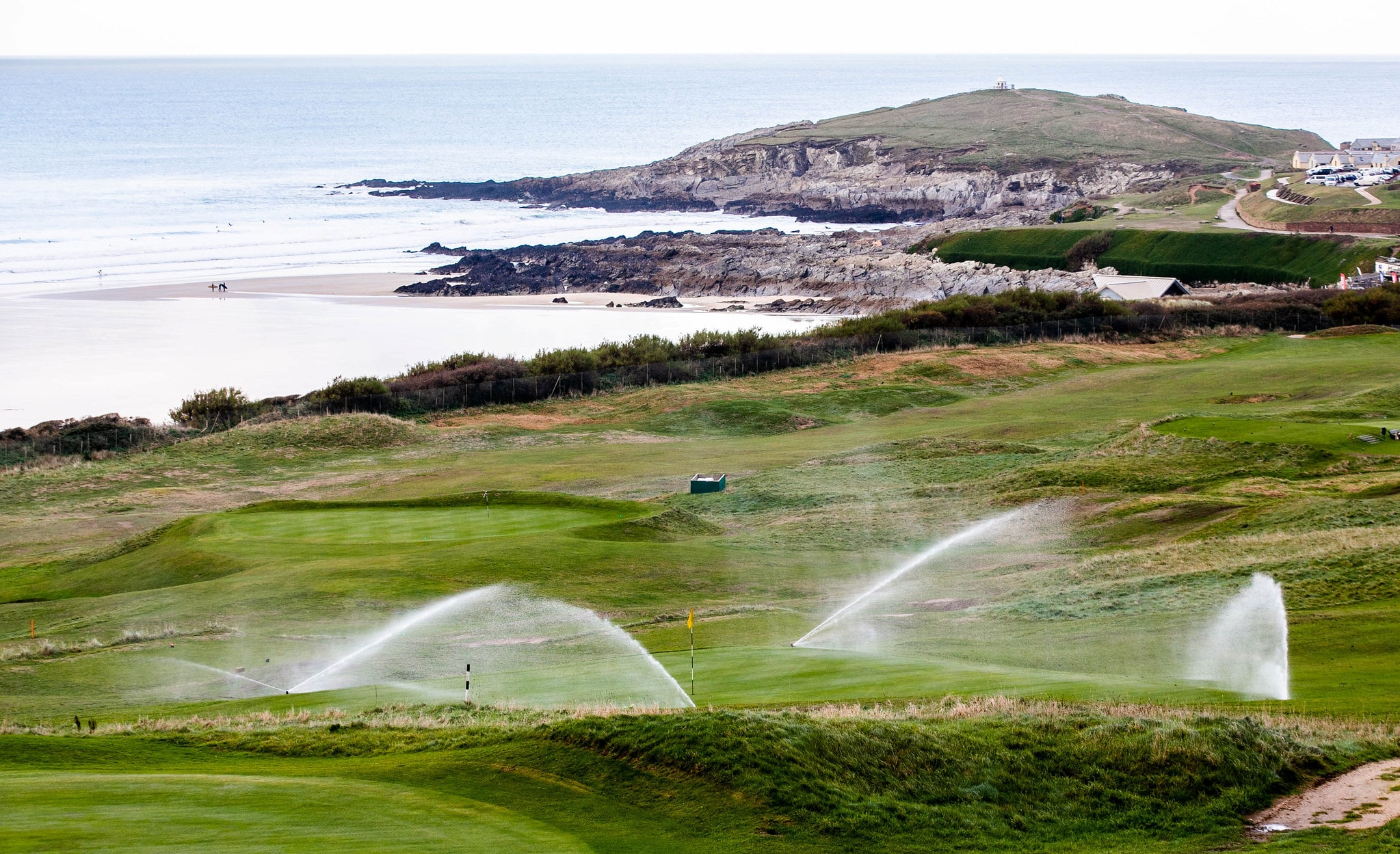 Two Toro sprinklers spraying water across a green at Kings Golf Club.