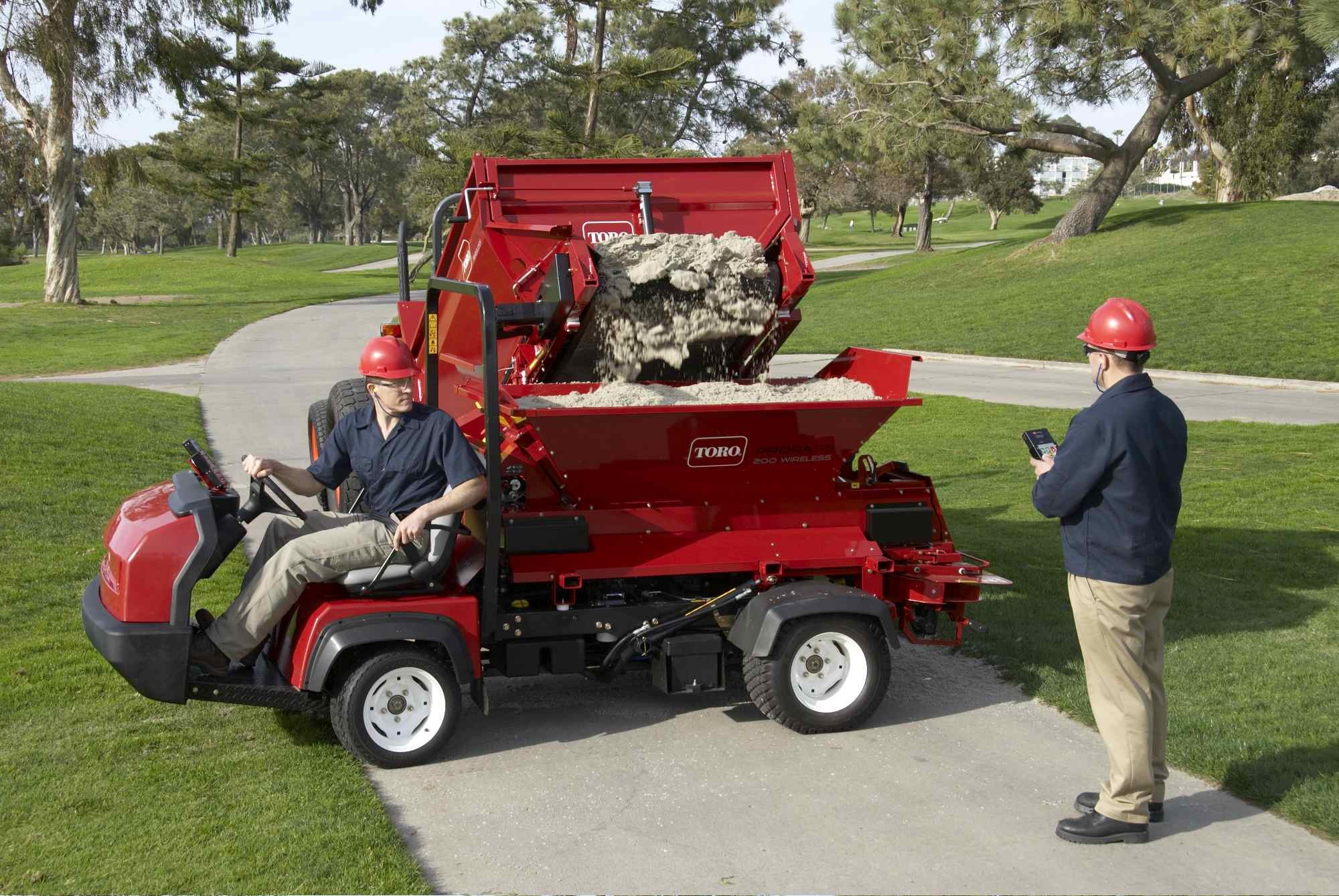 A Toro ProPass being loaded with sand ahead of topdressing.