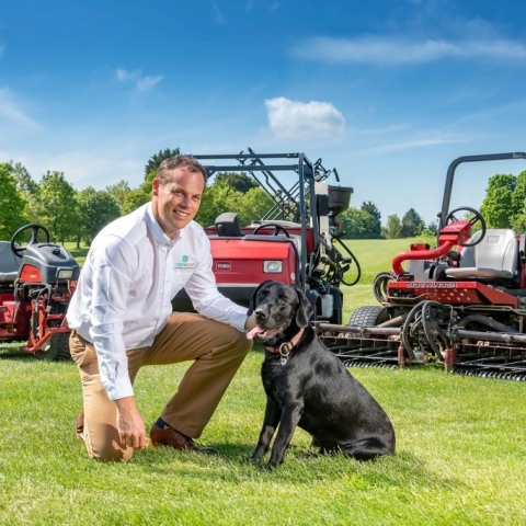 Simon Fitton, managing director of Nene Golf Ltd, with Toro the dog and latest Toro machines.