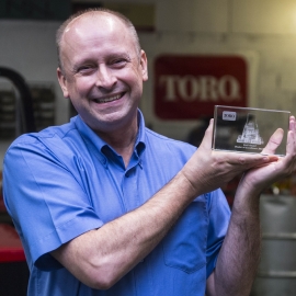 Service director Mark Woodward with Cheshire Turf Machinery’s Dealer of the Year Award for Excellence in Customer Support.